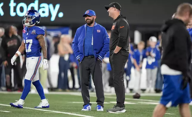 Cincinnati Bengals head coach Zac Taylor, center right, and New York Giants head coach Brian Daboll talk on the field before an NFL football game, Sunday, Oct. 13, 2024, in East Rutherford, N.J. (AP Photo/Frank Franklin II)