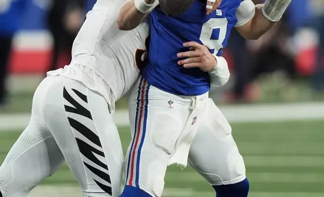 Cincinnati Bengals defensive end Trey Hendrickson (91) sacks New York Giants quarterback Daniel Jones (8) during the second half of an NFL football game, Sunday, Oct. 13, 2024, in East Rutherford, N.J. (AP Photo/Frank Franklin II)