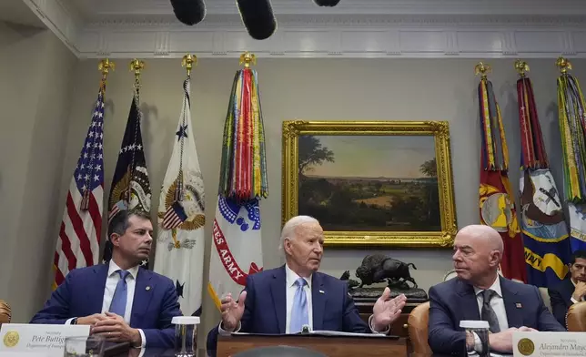 President Joe Biden speaks during a briefing on the government's response to Hurricane Helene in the Roosevelt Room of the White House in Washington, Tuesday, Oct. 1, 2024, as Secretary of Transportation Pete Buttigieg, left, and Secretary of Homeland Security Alejandro Mayorkas, right, look on. (AP Photo/Mark Schiefelbein)