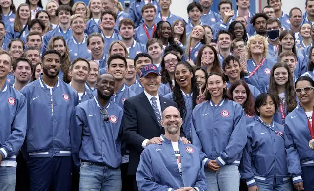 President Joe Biden, front row center, takes a photo with attendees at an event celebrating the 2024 U.S. Olympic and Paralympic teams on the South Lawn of the White House in Washington, Monday, Sept. 30, 2024. (AP Photo/Susan Walsh)