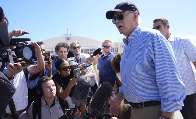 President Joe Biden speaks to reporters at MacDill Air Force Base, Sunday, Oct. 13, 2024, in Tampa, Fla., before departing to Philadelphia following a tour of areas in Florida affected by Hurricane Milton. (AP Photo/Manuel Balce Ceneta)