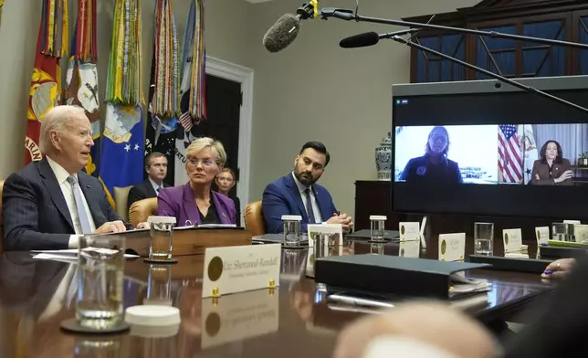 President Joe Biden, from left, joined by Energy Secretary Jennifer Granholm, White House climate adviser Ali Zaidi, and on screen from left, FEMA Administrator Deanne Criswell and Vice President Kamala Harris, speaks about the federal government's response to Hurricanes Milton and Helene, in the Roosevelt Room of the White House, Friday, Oct. 11, 2024, in Washington. (AP Photo/Manuel Balce Ceneta)