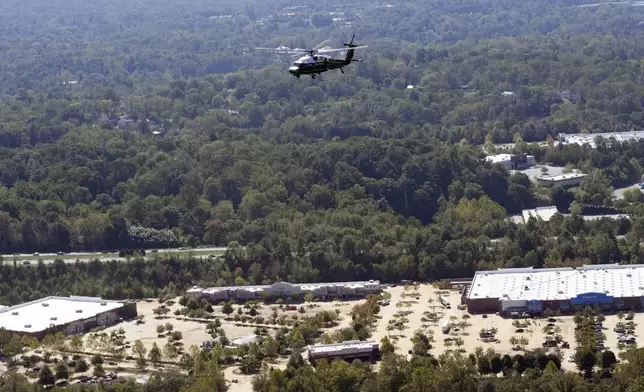 Marine One, with President Joe Biden on board, flies over areas impacted by Hurricane Helene over downtown Asheville, N.C., Wednesday, Oct. 2, 2024. (AP Photo/Susan Walsh) (AP Photo/Susan Walsh)