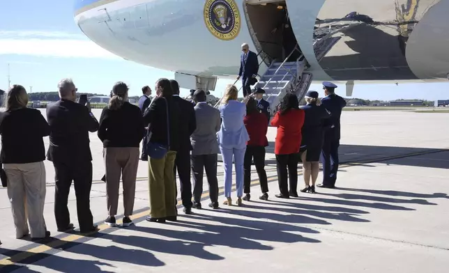 President Joe Biden is greeted by officials as he arrives at Milwaukee Mitchell International Airport in Milwaukee, Tuesday, Oct. 8, 2024. (AP Photo/Susan Walsh)