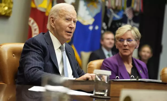 President Joe Biden speaks about the federal government's response to Hurricanes Milton and Helene as as Energy Secretary Jennifer Granholm listens, in the Roosevelt Room of the White House, Friday, Oct. 11, 2024, in Washington. (AP Photo/Manuel Balce Ceneta)