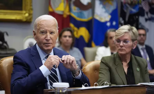 President Joe Biden delivers remarks on the federal government's response to Hurricane Helene and preparations for Hurricane Milton in the Roosevelt Room of the White House, Tuesday, Oct. 8, 2024, in Washington, as Secretary of Energy Jennifer Granholm looks on. (AP Photo/Evan Vucci)