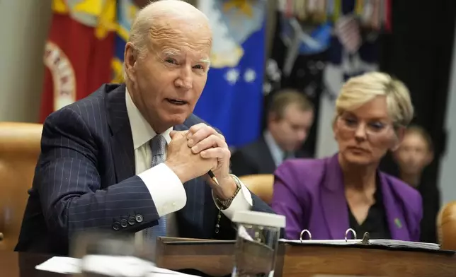 President Joe Biden speaks about the federal government's response to Hurricanes Milton and Helene as as Energy Secretary Jennifer Granholm listens, in the Roosevelt Room of the White House, Friday, Oct. 11, 2024, in Washington. (AP Photo/Manuel Balce Ceneta)