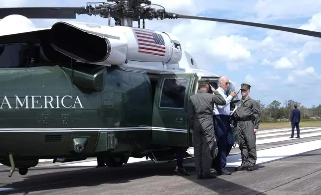 President Joe Biden walks off Marine One, after flying around areas impacted by Hurricane Helene near Perry, Fla., Thursday, Oct. 3, 2024. (AP Photo/Susan Walsh)