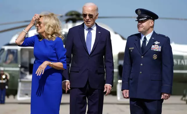 President Joe Biden and first lady Jill Biden walk to board Air Force One at Joint Base Andrews, Md., Saturday, Oct. 5, 2024, with Col. Paul Pawluk, Vice Commander of the 89th Airlift Wing. (AP Photo/Manuel Balce Ceneta)