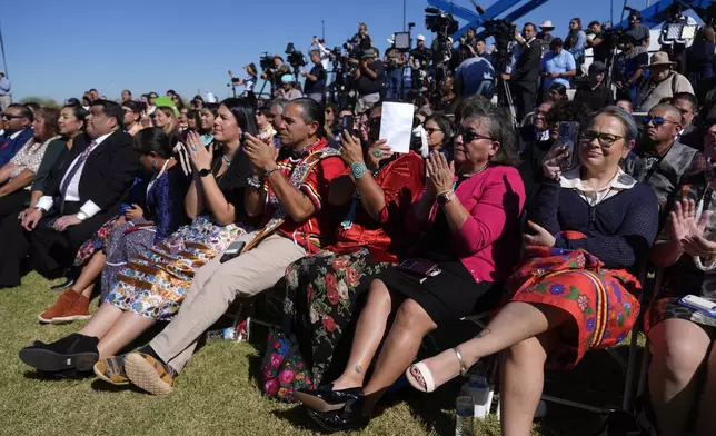 Attendees listen as Interior Secretary Deb Haaland speaks before President Joe Biden at the Gila Crossing Community School in the Gila River Indian Community reservation in Laveen, Ariz., Friday, Oct. 25, 2024. (AP Photo/Manuel Balce Ceneta)