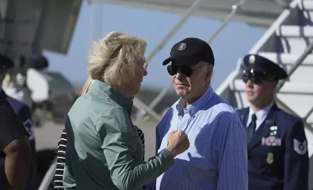 Tampa, Fla. Mayor Jane Castor, left, speaks with President Joe Biden as he arrives at MacDill Air Force Base, Sunday, Oct. 13, 2024, in Tampa, Fla. (AP Photo/Manuel Balce Ceneta)