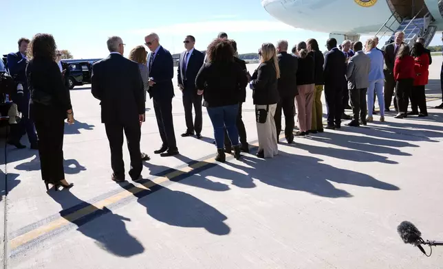 President Joe Biden is greeted by officials after arriving at Milwaukee Mitchell International Airport in Milwaukee, Tuesday, Oct. 8, 2024. (AP Photo/Susan Walsh)