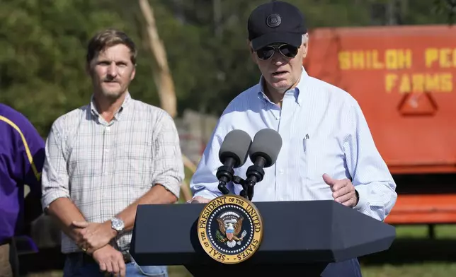 President Joe Biden speaks at Shiloh Pecan Farm as property manager Buck Paulk looks on in Ray City, Ga., Thursday, Oct. 3, 2024, as part of Biden's trip to see areas impacted by Hurricane Helene. (AP Photo/Susan Walsh)