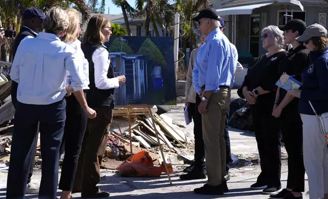 President Joe Biden, center right, is briefed by federal, state, and local officials in St. Pete Beach, Fla., following an aerial tour of the Hurricane Milton affected areas, Sunday, Oct. 13, 2024. (AP Photo/Manuel Balce Ceneta)