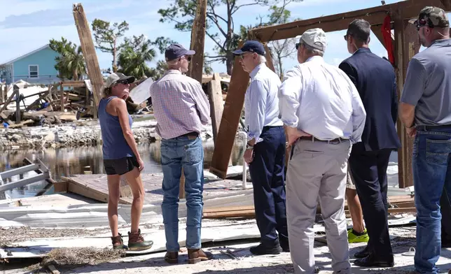 President Joe Biden speaks with Sen. Rick Scott, R-Fla., in Keaton Beach, Fla., Thursday, Oct. 3, 2024, during his tour of areas impacted by Hurricane Helene. (AP Photo/Susan Walsh)