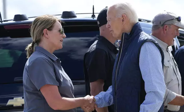 President Joe Biden talks with Deanne Criswell, Administrator of the Federal Emergency Management Agency (FEMA), as he arrives at Greenville-Spartanburg International Airport in Greer, S.C., Wednesday, Oct. 2, 2024, to survey damage from Hurricane Helene. (AP Photo/Susan Walsh)