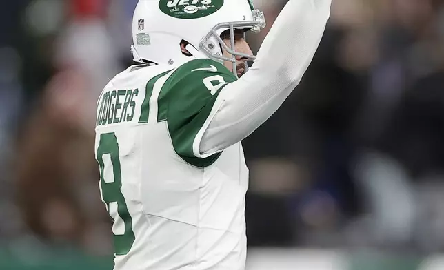 New York Jets quarterback Aaron Rodgers (8) celebrates after throwing a touchdown pass to wide receiver Allen Lazard during the first half of an NFL football game against the Buffalo Bills in East Rutherford, N.J., Monday, Oct. 14, 2024. (AP Photo/Adam Hunger)