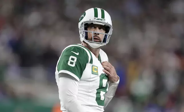 New York Jets quarterback Aaron Rodgers walks on the field during the second half of an NFL football game against the Buffalo Bills in East Rutherford, N.J., Monday, Oct. 14, 2024. (AP Photo/Adam Hunger)