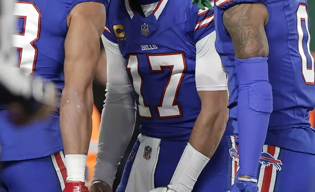 Buffalo Bills wide receiver Mack Hollins, left, celebrates with quarterback Josh Allen (17) and wide receiver Keon Coleman (0) after scoring against the New York Jets during the first half of an NFL football game in East Rutherford, N.J., Monday, Oct. 14, 2024. (AP Photo/Adam Hunger)