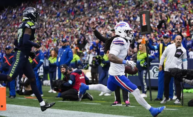 Buffalo Bills running back James Cook (4) scores a touchdown during the second half of an NFL football game against the Seattle Seahawks, Sunday, Oct. 27, 2024, in Seattle. (AP Photo/Lindsey Wasson)