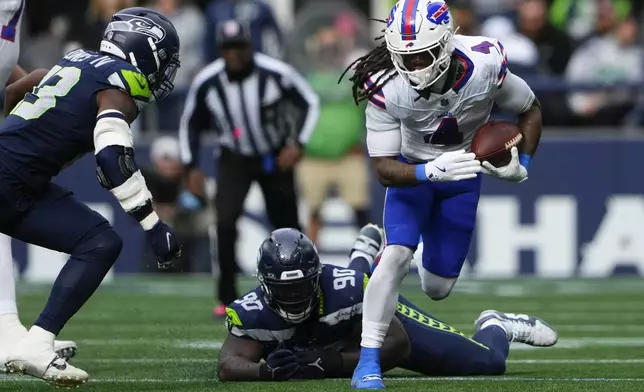 Seattle Seahawks defensive tackle Jarran Reed (90) misses a tackle against Buffalo Bills running back James Cook (4) during the first half of an NFL football game, Sunday, Oct. 27, 2024, in Seattle. (AP Photo/Lindsey Wasson)