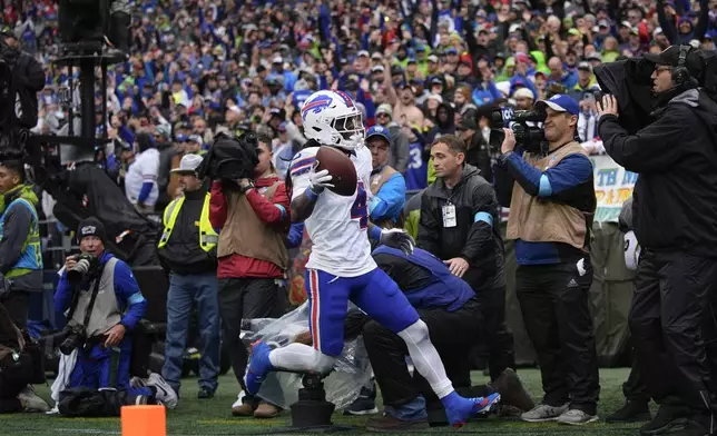 Buffalo Bills running back James Cook (4) reacts after scoring a touchdown during the second half of an NFL football game, Sunday, Oct. 27, 2024, in Seattle. (AP Photo/Lindsey Wasson)