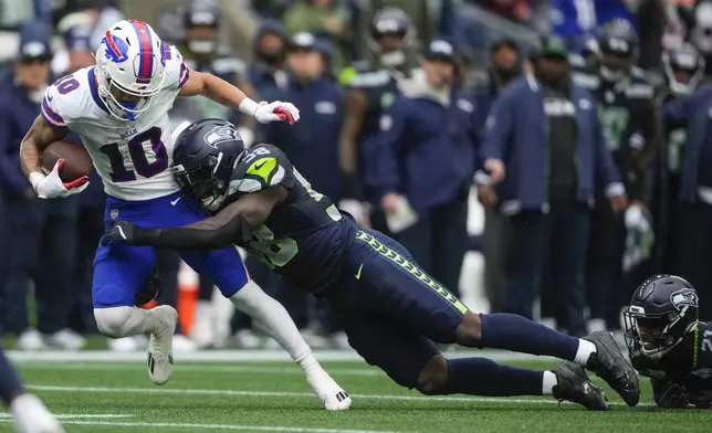 Buffalo Bills wide receiver Khalil Shakir (10) is tackled by Seattle Seahawks linebacker Derick Hall (58) during the second half of an NFL football game, Sunday, Oct. 27, 2024, in Seattle. (AP Photo/Lindsey Wasson)