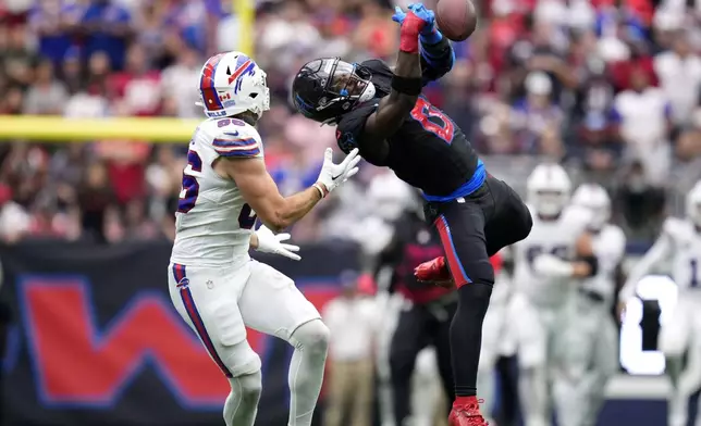 Houston Texans linebacker Azeez Al-Shaair (0) breaks up a pass intended for Buffalo Bills tight end Dalton Kincaid (86) during the first half of an NFL football game, Sunday, Oct. 6, 2024, in Houston. (AP Photo/Eric Christian Smith)