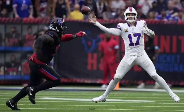 Buffalo Bills quarterback Josh Allen (17) throws a pass in front of Houston Texans defensive tackle Mario Edwards Jr., left, during the first half of an NFL football game, Sunday, Oct. 6, 2024, in Houston. (AP Photo/Eric Christian Smith)