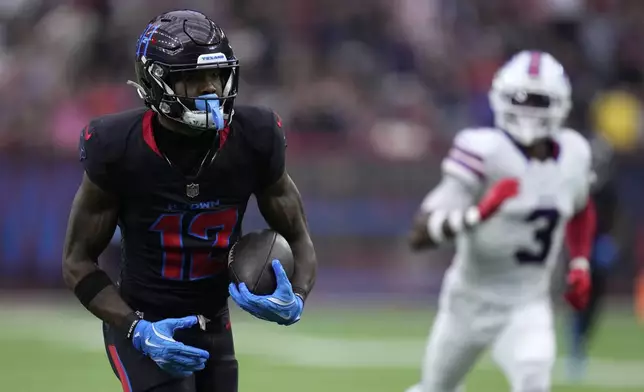 Houston Texans wide receiver Nico Collins (12) runs from Buffalo Bills safety Damar Hamlin (3) during a 67-yard touchdown reception in the first half of an NFL football game, Sunday, Oct. 6, 2024, in Houston. (AP Photo/Eric Christian Smith)