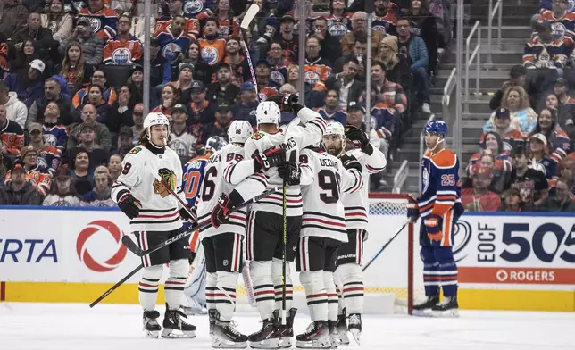 Chicago Blackhawks players celebrate a goal against the Edmonton Oilers during the second period of an NHL hockey game in Edmonton, Alberta, Saturday, Oct. 12, 2024. (Jason Franson/The Canadian Press via AP)