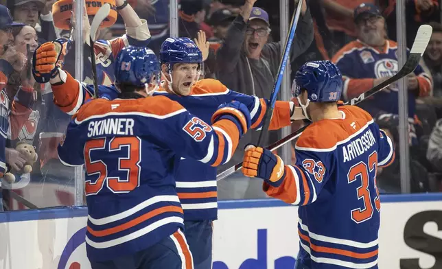 Edmonton Oilers' Jeff Skinner (53), Corey Perry (90) and Viktor Arvidsson (33) celebrate a goal against the Chicago Blackhawks during the second period of an NHL hockey game in Edmonton, Alberta, Saturday, Oct. 12, 2024. (Jason Franson/The Canadian Press via AP)