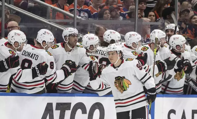 Chicago Blackhawks' Connor Bedard (98) celebrates a goal against the Edmonton Oilers during the second period of an NHL hockey game in Edmonton, Alberta, Saturday, Oct. 12, 2024. (Jason Franson/The Canadian Press via AP)