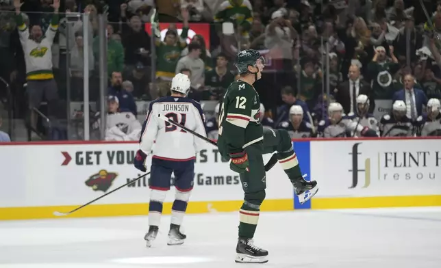 Minnesota Wild left wing Matt Boldy (12) celebrates after scoring during the first period of an NHL hockey game against the Columbus Blue Jackets, Thursday, Oct. 10, 2024, in St. Paul, Minn. (AP Photo/Abbie Parr)