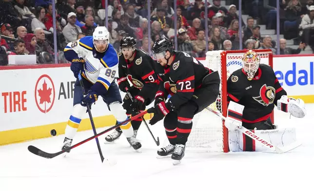 Ottawa Senators goaltender Linus Ullmark (right), looks towards the puck as St. Louis Blues left wing Pavel Buchnevich (89) gets pressured by Senators center Josh Norris (9) and defenseman Thomas Chabot (72) during the first period of an NHL hockey game in Ottawa, Ontario, Tuesday, Oct. 29, 2024. (Sean Kilpatrick/The Canadian Press via AP)