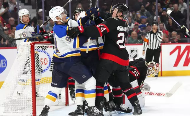 Ottawa Senators and St. Louis Blues players rough it up during the third period of an NHL hockey game in Ottawa, Ontario, Tuesday, Oct. 29, 2024. (Sean Kilpatrick/The Canadian Press via AP)