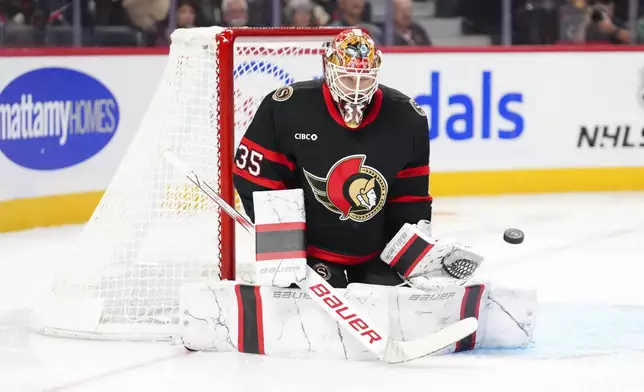 Ottawa Senators goaltender Linus Ullmark (35) keeps his eye on the puck as he makes a save against the St. Louis Blues during an NHL hockey game in Ottawa, Ontario, Tuesday, Oct. 29, 2024. (Sean Kilpatrick/The Canadian Press via AP)