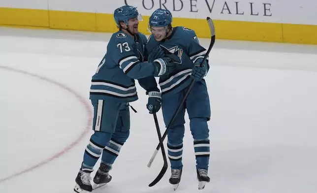 San Jose Sharks' Tyler Toffoli, left, celebrates with Macklin Celebrini, right, after scoring during the first period of an NHL hockey game against the St. Louis Blues, Thursday, Oct. 10, 2024, in San Jose, Calif. (AP Photo/Godofredo A. Vásquez)