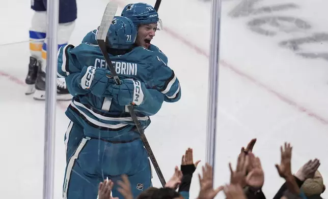 San Jose Sharks center Macklin Celebrini (71) is congratulated by left wing William Eklund (72) following his goal against the St. Louis Blues during the first period of an NHL hockey game Thursday, Oct. 10, 2024, in San Jose, Calif. (AP Photo/Godofredo A. Vásquez)