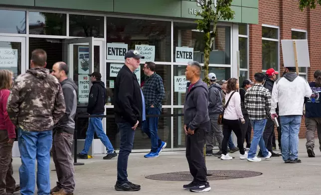 Boeing employees on strike arrive to vote on a new contract offer from the company, Wednesday, Oct. 23, 2024, at a voting location in the Angel of the Winds Arena in Everett, Wash. (AP Photo/Lindsey Wasson)