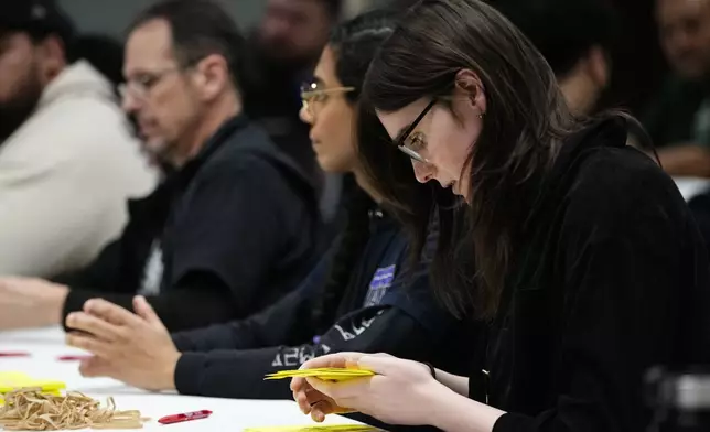 Volunteers tally votes on a new contract offer from Boeing, Wednesday, Oct. 23, 2024, at Seattle Union Hall in Seattle. (AP Photo/Lindsey Wasson)