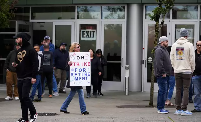 A worker holds a sign as Boeing employees vote on a new contract offer from the company, Wednesday, Oct. 23, 2024, at a voting location in the Angel of the Winds Arena in Everett, Wash. (AP Photo/Lindsey Wasson)