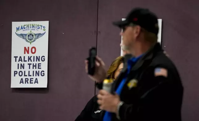 Union members watch as volunteers tally votes on a new contract offer from Boeing, Wednesday, Oct. 23, 2024, at Seattle Union Hall in Seattle. (AP Photo/Lindsey Wasson)