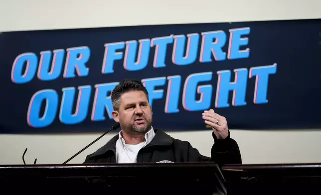 IAM District 751 president Jon Holden speaks to union members while announcing that they voted to reject a new contract offer from Boeing, Wednesday, Oct. 23, 2024, at Seattle Union Hall in Seattle. (AP Photo/Lindsey Wasson)