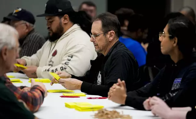 Volunteers tally votes on a new contract offer from Boeing, Wednesday, Oct. 23, 2024, at Seattle Union Hall in Seattle. (AP Photo/Lindsey Wasson)