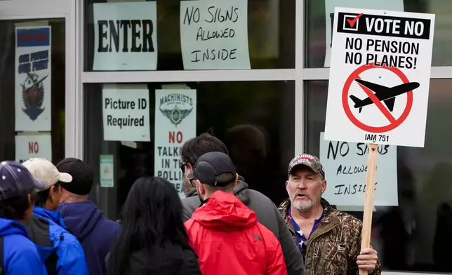 Bartley Stokes Sr., who has worked for Boeing for 46 years, encourages other employees on strike to vote no on a new contract offer from the company Wednesday, Oct. 23, 2024, at a voting location in the Angel of the Winds Arena in Everett, Wash. (AP Photo/Lindsey Wasson)