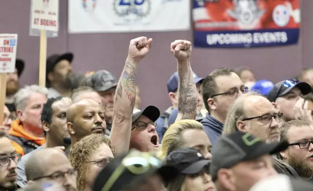 A man cheers during a rally by Boeing machinists, labor allies and elected officials at their union hall, Tuesday, Oct. 15, 2024, in Seattle. (AP Photo/Manuel Valdes)