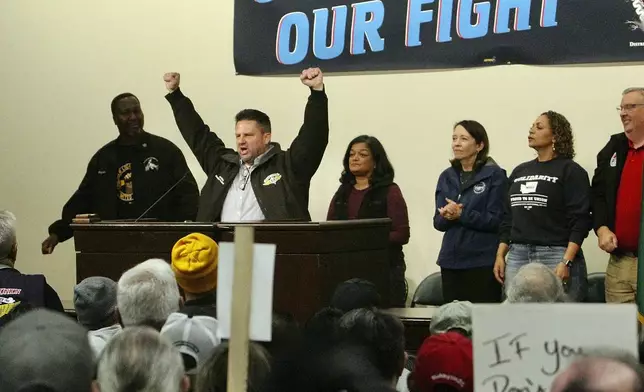 Jon Holden, IAM District 751 President, raises his arms as Sen. Maria Cantwell, D-Wash., Rep. Pramila Jayapal, D-Wash., and labor leaders stand behind him at a rally for Boeing union machinists, Tuesday, Oct. 15, 2024, in Seattle. (AP Photo/Manuel Valdes)