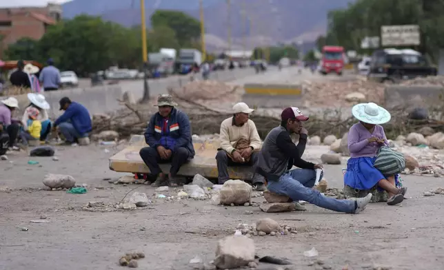 Supporters of former Bolivian President Evo Morales block a road as pressure to prevent the former leader from facing a criminal investigation over allegations of abuse of a minor, near Cochabamba, Bolivia, Saturday, Oct. 26, 2024. (AP Photo/Juan Karita)