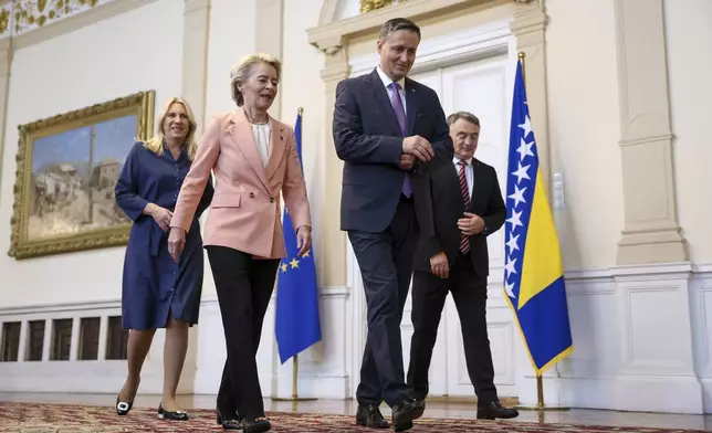 European Commission President Ursula von der Leyen, front left, walks with the member of the Bosnian Presidency Denis Becirovic, right foreground, prior to the start of their meeting in Sarajevo, Bosnia, Friday, Oct. 25, 2024. (AP Photo/Armin Durgut)